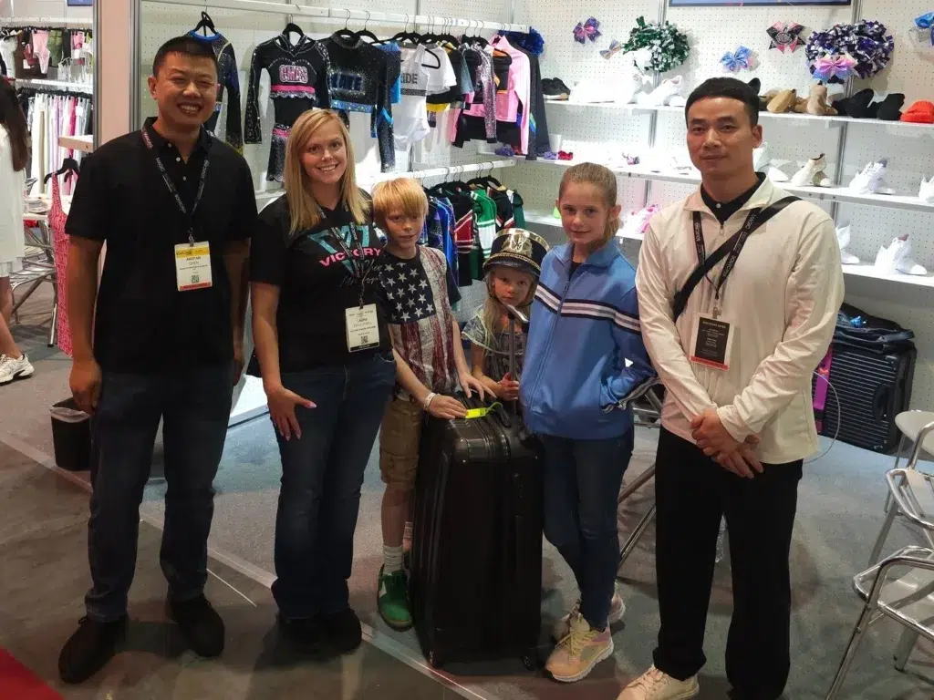 Laura and her family at a Vendor Sourcing show in Las Vegas for Victory Cheer Uniforms