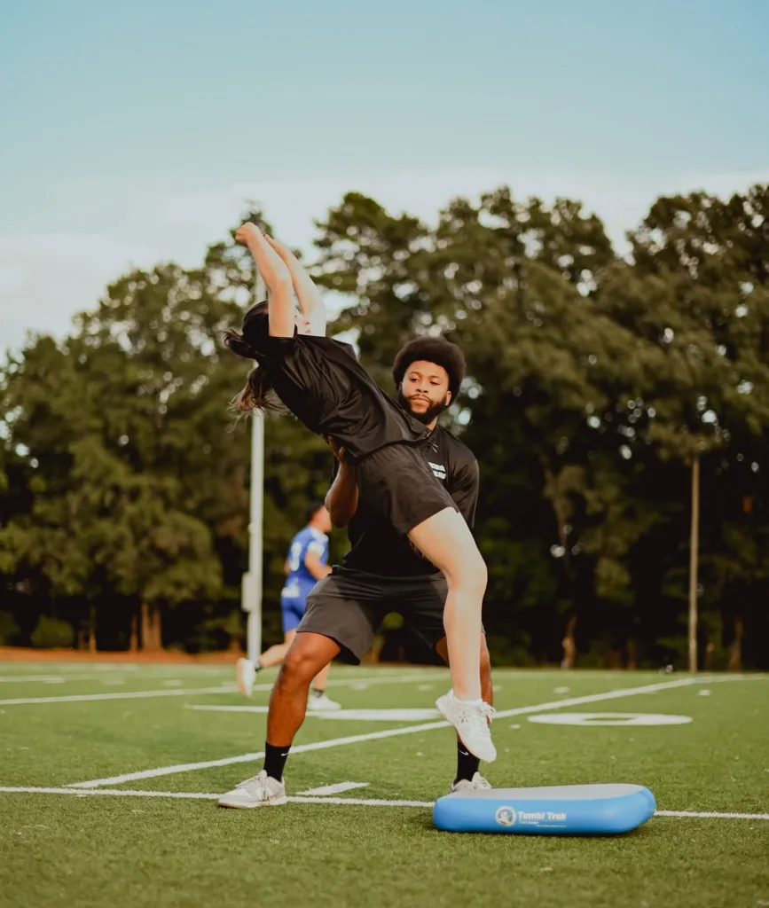 Vonté Patterson working one-on-one with an athlete on her tumbling shapes and power drills skills